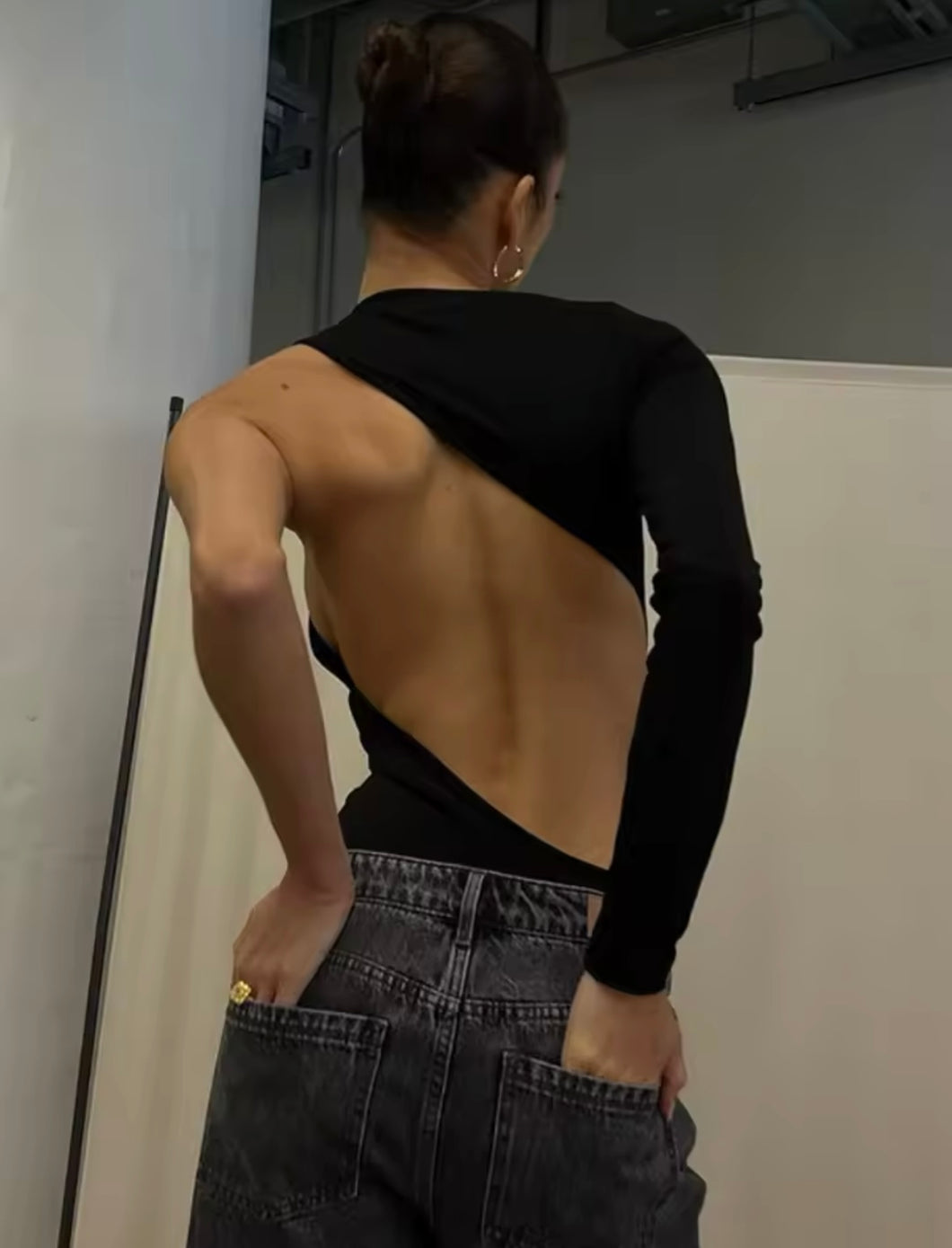 Asymmetrical backless black bodysuit